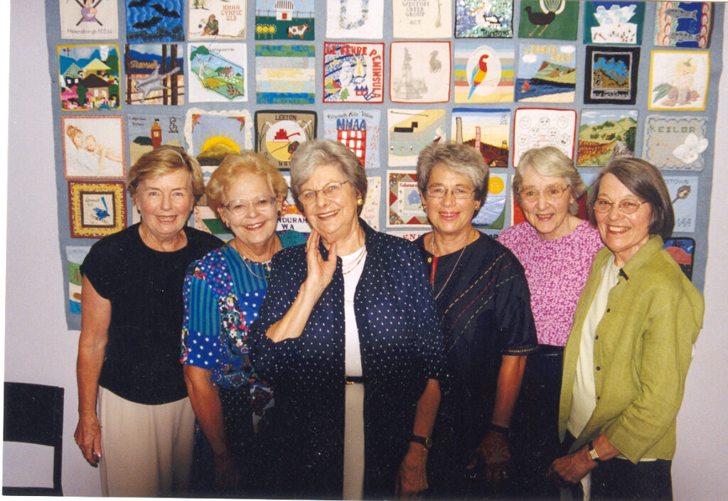 Founding-mothers-in-front-of-quilt